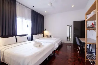 a hotel room with two beds and a desk at Bukit Damansara Terrace in Kuala Lumpur