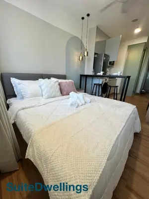 a bedroom with a large bed with towels on it at TheRiv Boutique Suites at Riveria City KL Sentral by Suite Dwellings in Kuala Lumpur