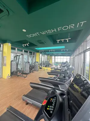 a gym with a row of treadmills and machines at TheRiv Boutique Suites at Riveria City KL Sentral by Suite Dwellings in Kuala Lumpur