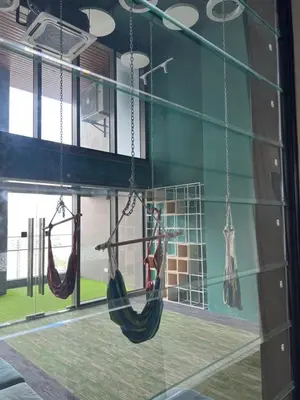 a room with two hammocks hanging from a window at TheRiv Boutique Suites at Riveria City KL Sentral by Suite Dwellings in Kuala Lumpur
