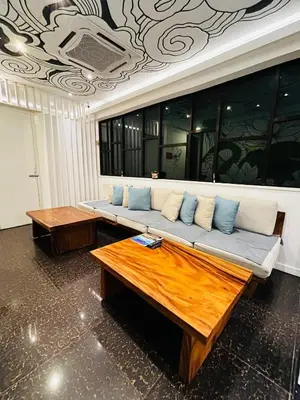 a living room with a couch and two tables at Vivids Hotel Bukit Bintang in Kuala Lumpur