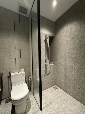a bathroom with a toilet and a shower at SKYLINE HOME BY SCARLETZ SUITEs KLCC in Kuala Lumpur