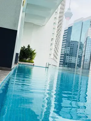 a swimming pool in a city with tall buildings at Bukit Ceylon Suites At RMAD KLCC in Kuala Lumpur