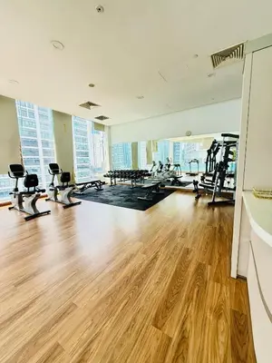 an empty gym with treadmills and exercise bikes at Bukit Ceylon Suites At RMAD KLCC in Kuala Lumpur