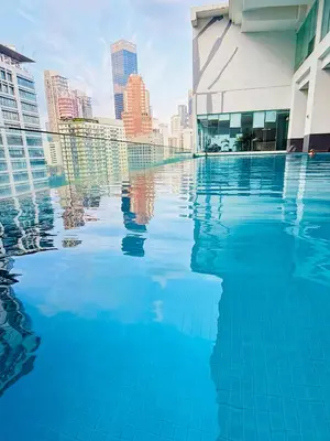 a swimming pool with a city in the background at Bukit Ceylon Suites At RMAD KLCC in Kuala Lumpur