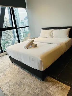 a large bed in a room with a large window at Scarletz Suites KLCC by Dream in Kuala Lumpur