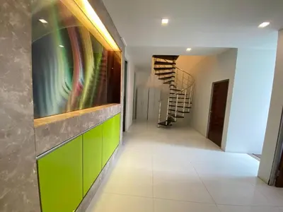 a hallway with green cabinets and a spiral staircase at Female Hostel wakakapacker in Kuala Lumpur