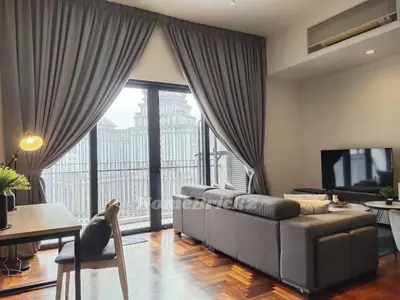 a living room with a couch and a large window at The Mews KLCC by Homebrickz in Kuala Lumpur