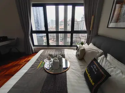 a hotel room with a bed with a large window at The Mews KLCC by Homebrickz in Kuala Lumpur