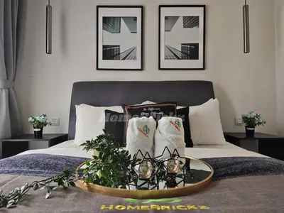 a bedroom with a bed with a tray with candles on it at The Mews KLCC by Homebrickz in Kuala Lumpur