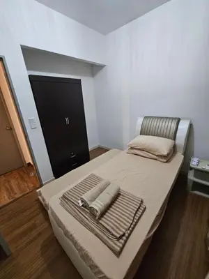 a bedroom with a bed with two towels on it at Ourstay M Vertica 49th floor Kuala Lumpur City View near Ikea with level 1 car park & 6 minutes walk to Maluri MRT in Kuala Lumpur