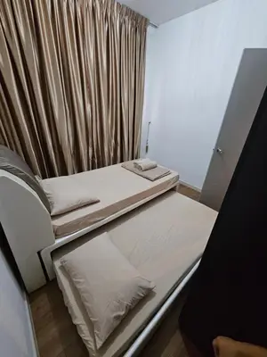 a room with two beds and a curtain at Ourstay M Vertica 49th floor Kuala Lumpur City View near Ikea with level 1 car park & 6 minutes walk to Maluri MRT in Kuala Lumpur