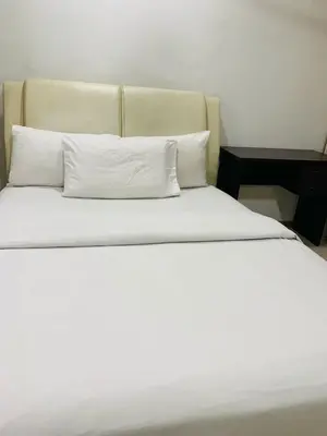 a large bed with white sheets and pillows at Residence at tarragon kl in Kuala Lumpur