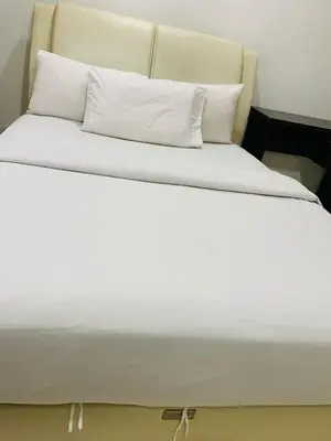 a large bed with white sheets and pillows at Residence at tarragon kl in Kuala Lumpur