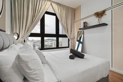 a bedroom with a white bed with a suitcase on it at Trendy 3BR MVertica Near MRT by RumaBnB in Kuala Lumpur