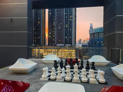 a chess game on a table with a view of a city at lavile 3 \u623f in Kuala Lumpur