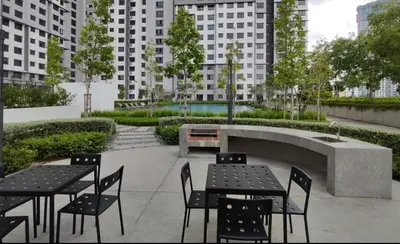 a patio with tables and chairs and a fountain at 10pax Comfy Homestay 5 Min-MITEC in Kuala Lumpur