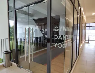 a glass door in a building with a sign on it at 10pax Comfy Homestay 5 Min-MITEC in Kuala Lumpur
