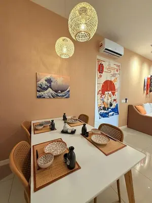 a room with a table and chairs with bowls at 10pax Comfy Homestay 5 Min-MITEC in Kuala Lumpur