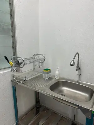 a sink with a metal shelf next to a mirror at Cozy 2BR Apt AxisAtrium Mall wPool Pandan Indah Ampang Kuala Lumpur in Ampang