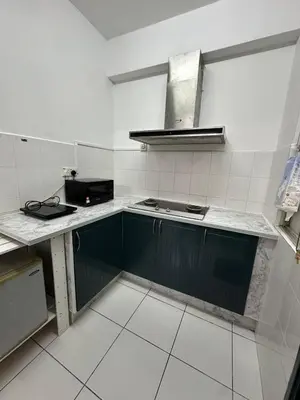 a kitchen with green cabinets and a stove at Cozy 2BR Apt AxisAtrium Mall wPool Pandan Indah Ampang Kuala Lumpur in Ampang