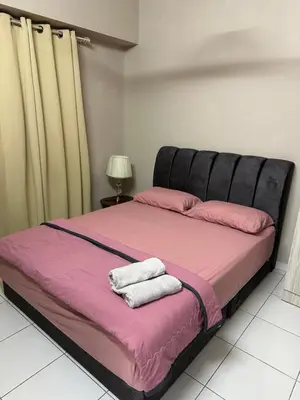 a bed with two towels on it in a room at Cozy 2BR Apt AxisAtrium Mall wPool Pandan Indah Ampang Kuala Lumpur in Ampang
