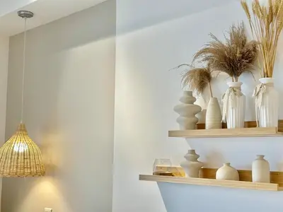 a shelf with white vases and a light fixture at 7Pax Muji Continew KL Centre View 10mins to TRX KLCC IKEA in Kuala Lumpur