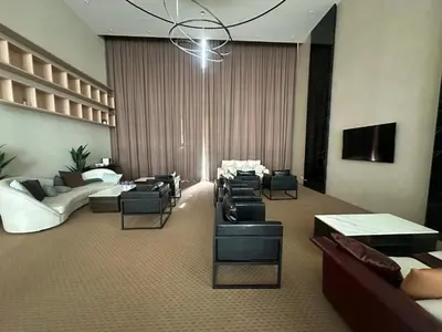 a lobby with couches and chairs and a chandelier at Skyline Homes by Reizz in Kuala Lumpur