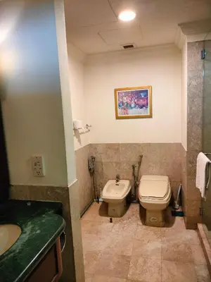 a bathroom with a toilet and a sink at Quitecove Service Suite at Times Square KL in Kuala Lumpur