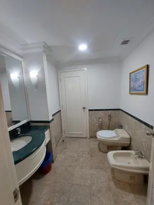 a bathroom with two toilets and a sink and a mirror at Quitecove Service Suite at Times Square KL in Kuala Lumpur