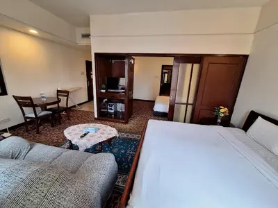 a hotel room with a large bed and a table at Urban Suite At Times Square KL in Kuala Lumpur