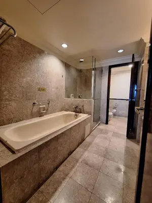 a large bathroom with a tub and a toilet at Urban Suite At Times Square KL in Kuala Lumpur