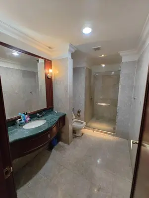 a bathroom with a sink and a shower and a toilet at Urban Suite At Times Square KL in Kuala Lumpur