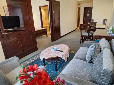a living room with a couch and a table at Urban Suite At Times Square KL in Kuala Lumpur