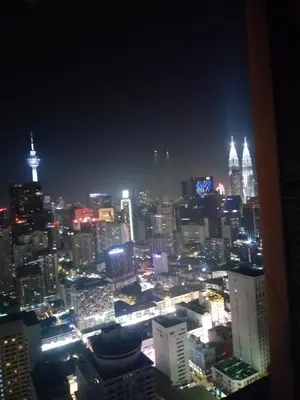 a view of a city at night with lights at Rainfall Suite And Service at Time Squre KL in Kuala Lumpur