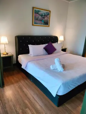 a bed with two stuffed animals on top of it at Rainfall Suite And Service at Time Squre KL in Kuala Lumpur