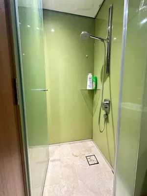 a bathroom with a shower with a glass door at Sky Suites KLCC by The Sense in Kuala Lumpur