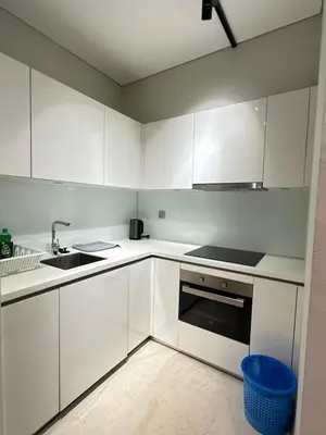 a white kitchen with white cabinets and a sink at Sky Suites KLCC by The Sense in Kuala Lumpur