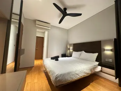 a bedroom with a bed with a ceiling fan at Sky Suites KLCC by The Sense in Kuala Lumpur