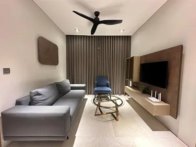 a living room with a couch and a ceiling fan at Sky Suites KLCC by The Sense in Kuala Lumpur