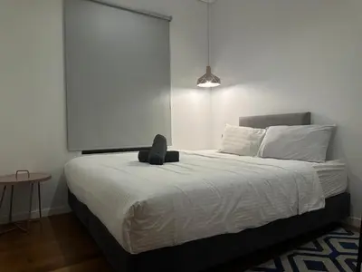 a stuffed animal sitting on a bed in a bedroom at Sky Suites KLCC by The Sense in Kuala Lumpur