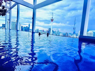 a swimming pool on top of a building with a city at Colony Relax Residences Klcc in Kuala Lumpur