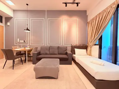 a living room with a couch and a table at Colony Greenfield Suites Klcc in Kuala Lumpur