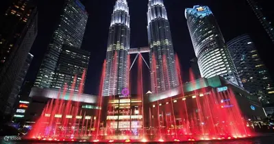 a group of tall buildings at night with red lights at CozyNest Suites Bukit Bintang in Kuala Lumpur