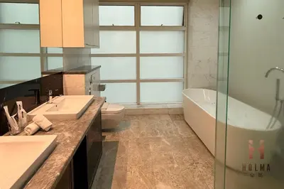 a bathroom with two sinks and a tub and a toilet at The Platinum KLCC by Holma in Kuala Lumpur