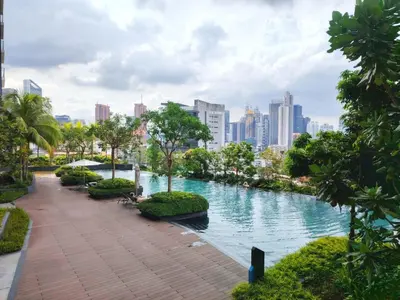 a river in a park with a city in the background at Residensi Continew 5 min walk MRT Train, TRX KL City Centre view Apartment in Kuala Lumpur