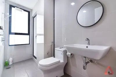 a bathroom with a toilet and a sink and a mirror at Residensi Continew 5 min walk MRT Train, TRX KL City Centre view Apartment in Kuala Lumpur