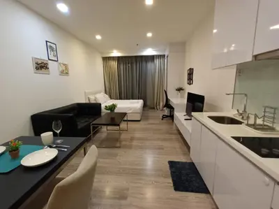 a kitchen and living room with a couch and a table at AK Residence in Kuala Lumpur