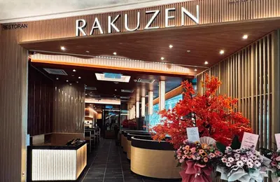 a restaurant with flowers in the front of a building at Cosy studio with King size bed \u9752\u65c5\u4e00\u65cf in Kuala Lumpur