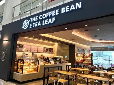a coffee bean and tea leaf store with tables and chairs at Cosy studio with King size bed \u9752\u65c5\u4e00\u65cf in Kuala Lumpur